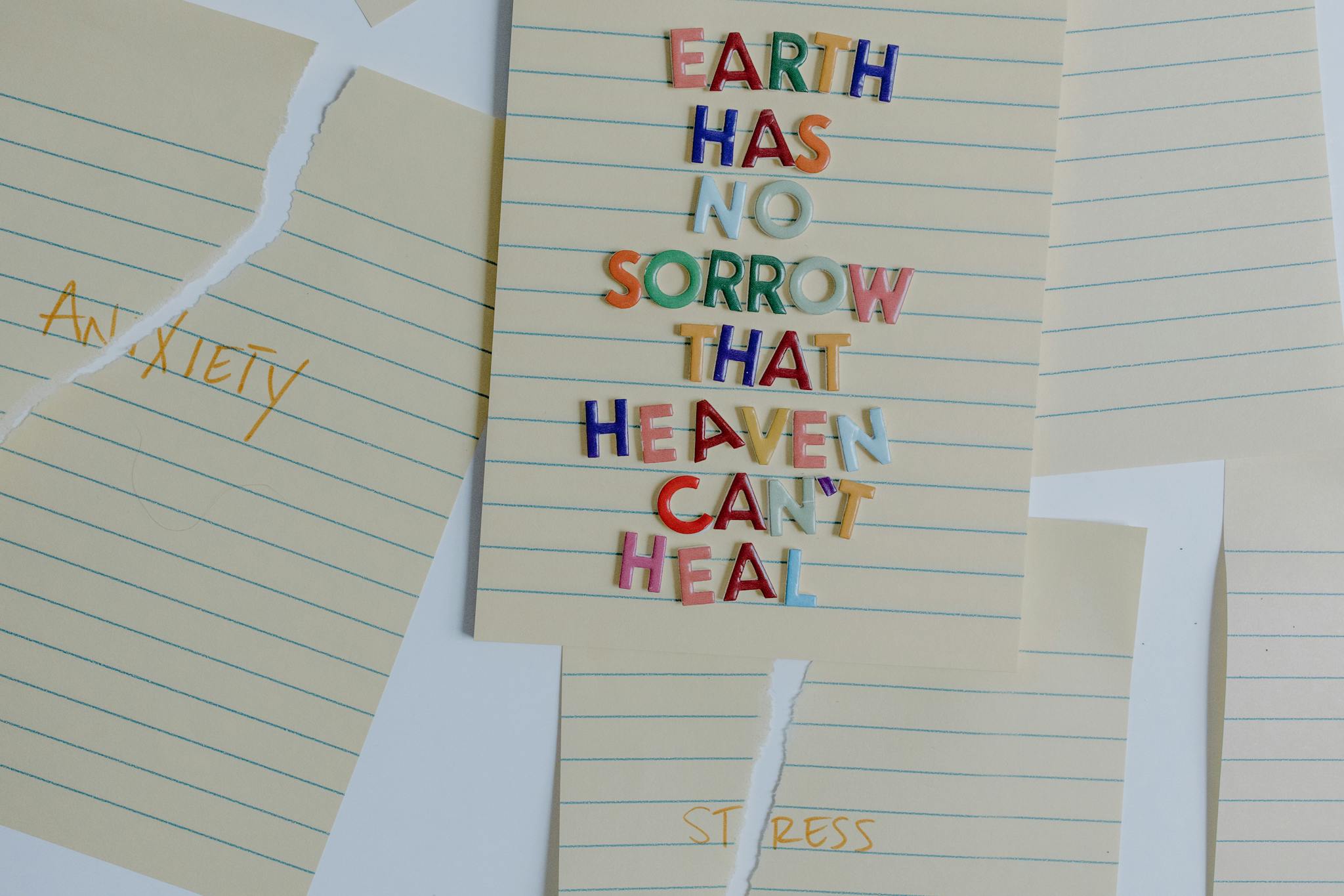 Torn papers with an uplifting quote emphasizing healing and overcoming anxiety and stress.